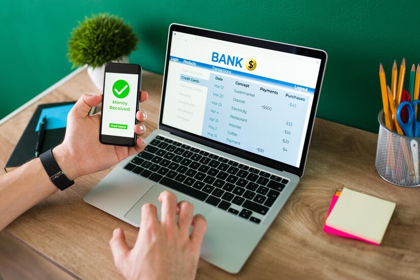 wire-transfer-young-man-using-his-smartphone-laptop-banking-transaction-some-payments_662251-2046.jpg